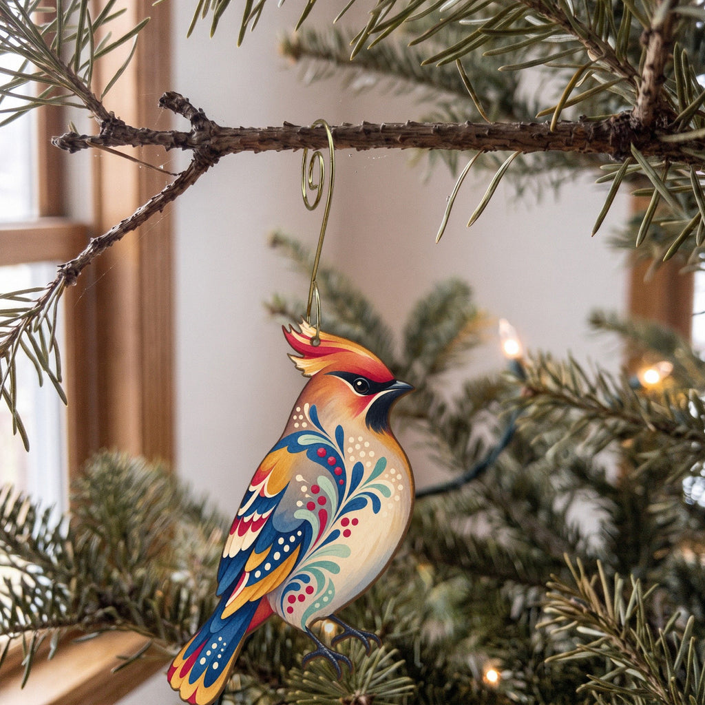 Laser-cut maple wood Bohemian Waxwing folk art ornament O309 hanging on a fir branch, made in USA