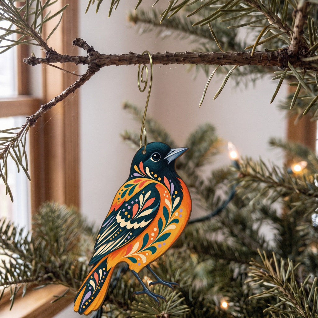 Laser-cut maple wood Baltimore Oriole folk art ornament O311 hanging on a fir branch, made in USA