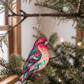 Laser-cut maple wood Purple Finch folk art ornament O313 hanging on a fir branch, made in USA