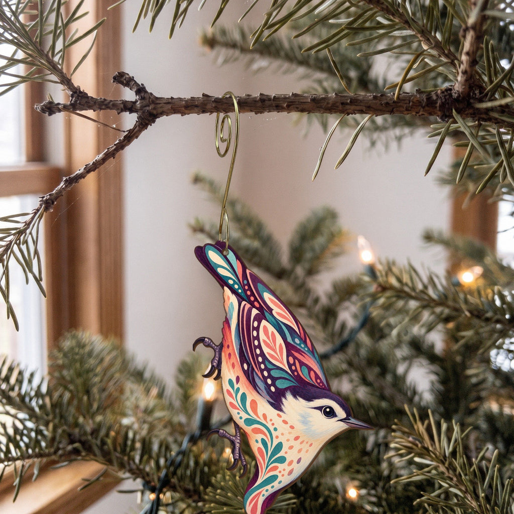 Laser-cut maple wood White-Breasted Nuthatch folk art ornament O316 hanging on a fir branch, made in USA