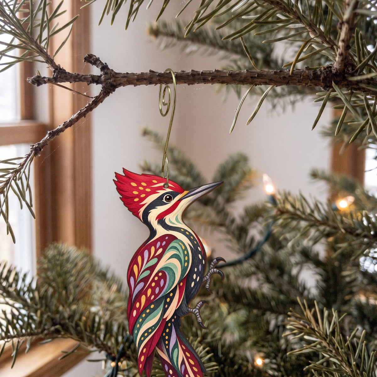 Laser-cut maple wood Pileated Woodpecker folk art ornament O318 hanging on a fir branch, made in USA