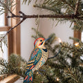 Laser-cut maple wood Northern Flicker folk art ornament O319 hanging on a fir branch, made in USA