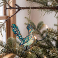 Laser-cut maple wood Greater Roadrunner folk art ornament O321 hanging on a fir branch, made in USA