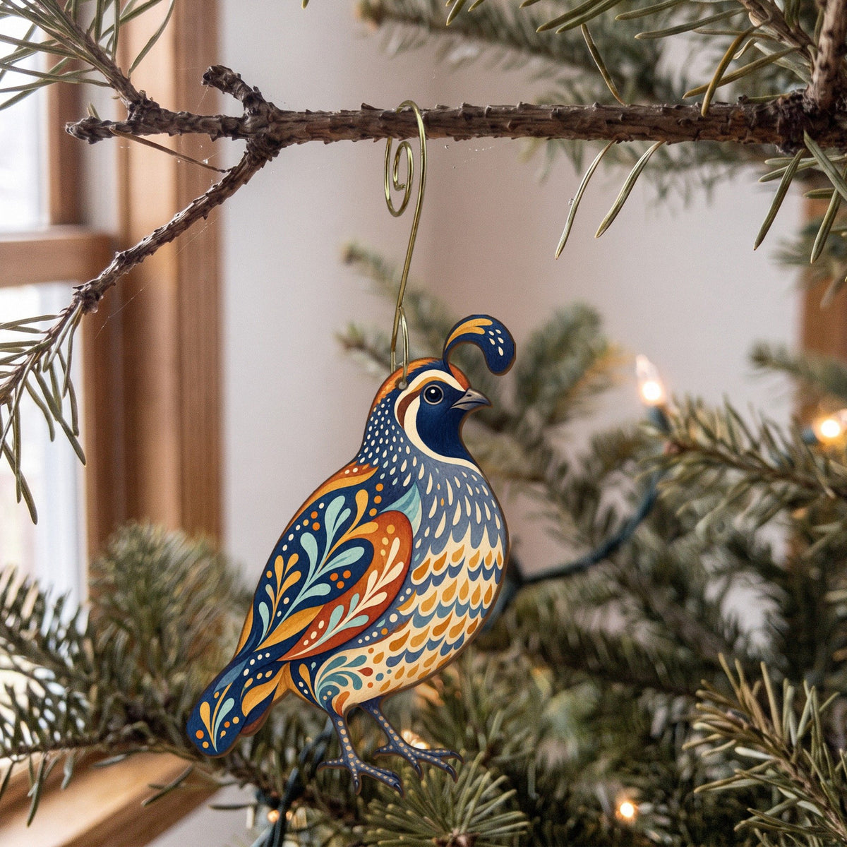 Laser-cut maple wood California Quail folk art ornament O322 hanging on a fir branch, made in USA