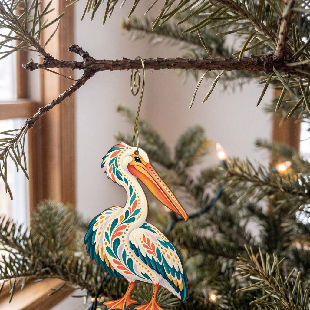 Laser-cut maple wood American White Pelican folk art ornament O327 hanging on a fir branch, made in USA