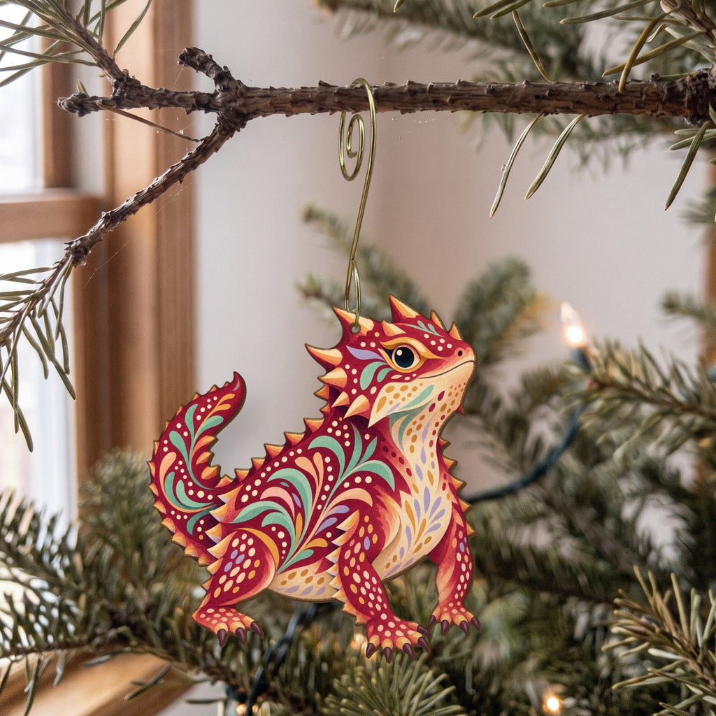 Laser-cut maple wood Horned Lizard folk art ornament O334 hanging on a fir branch, made in USA