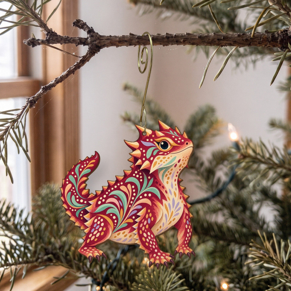 Laser-cut maple wood Horned Lizard folk art ornament O334 hanging on a fir branch, made in USA