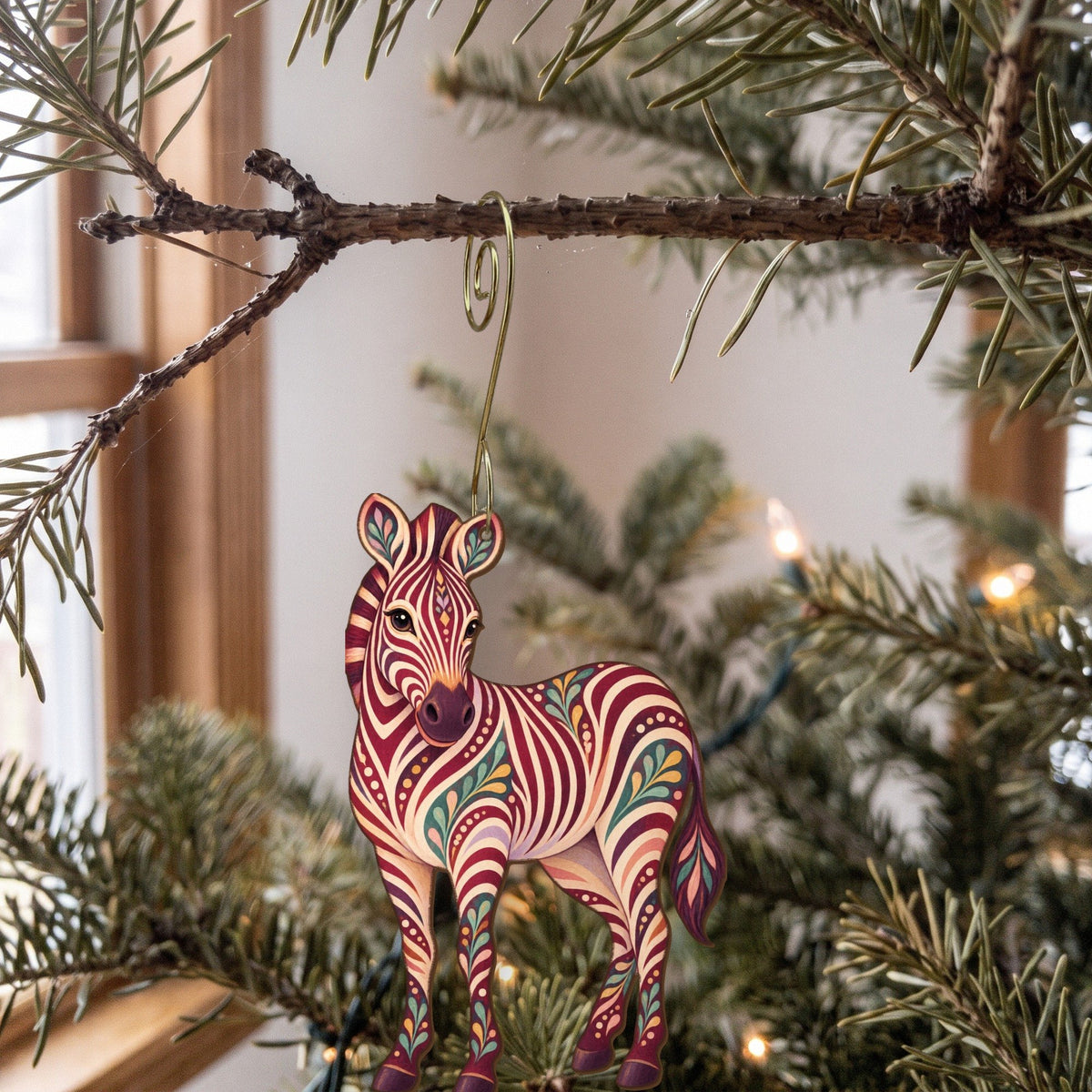 Laser-cut maple wood Grevy's Zebra folk art ornament O342 hanging on a fir branch, made in USA