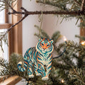 Laser-cut maple wood Amur Tiger folk art ornament O345 hanging on a fir branch, made in USA
