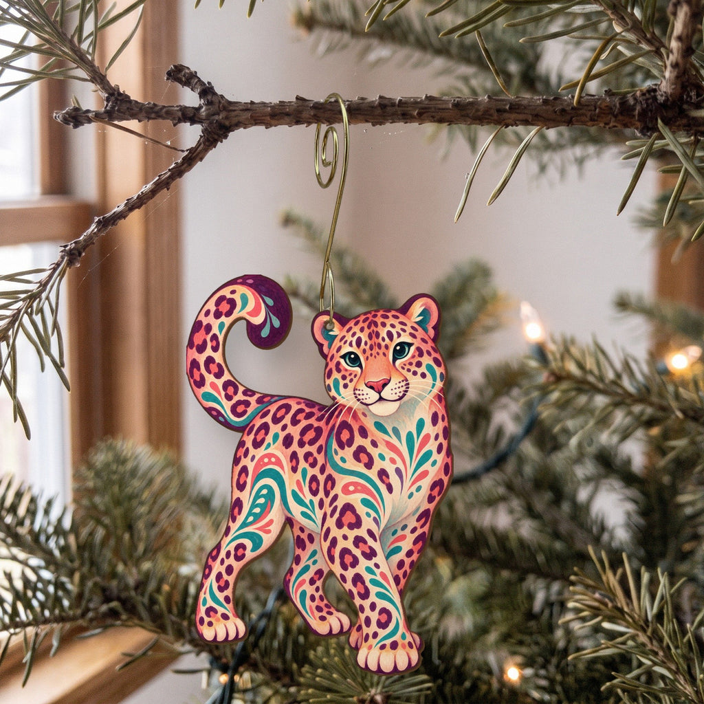 Laser-cut maple wood Amur Leopard folk art ornament O348 hanging on a fir branch, made in USA