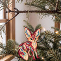 Laser-cut maple wood Fennec Fox folk art ornament O358 hanging on a fir branch, made in USA