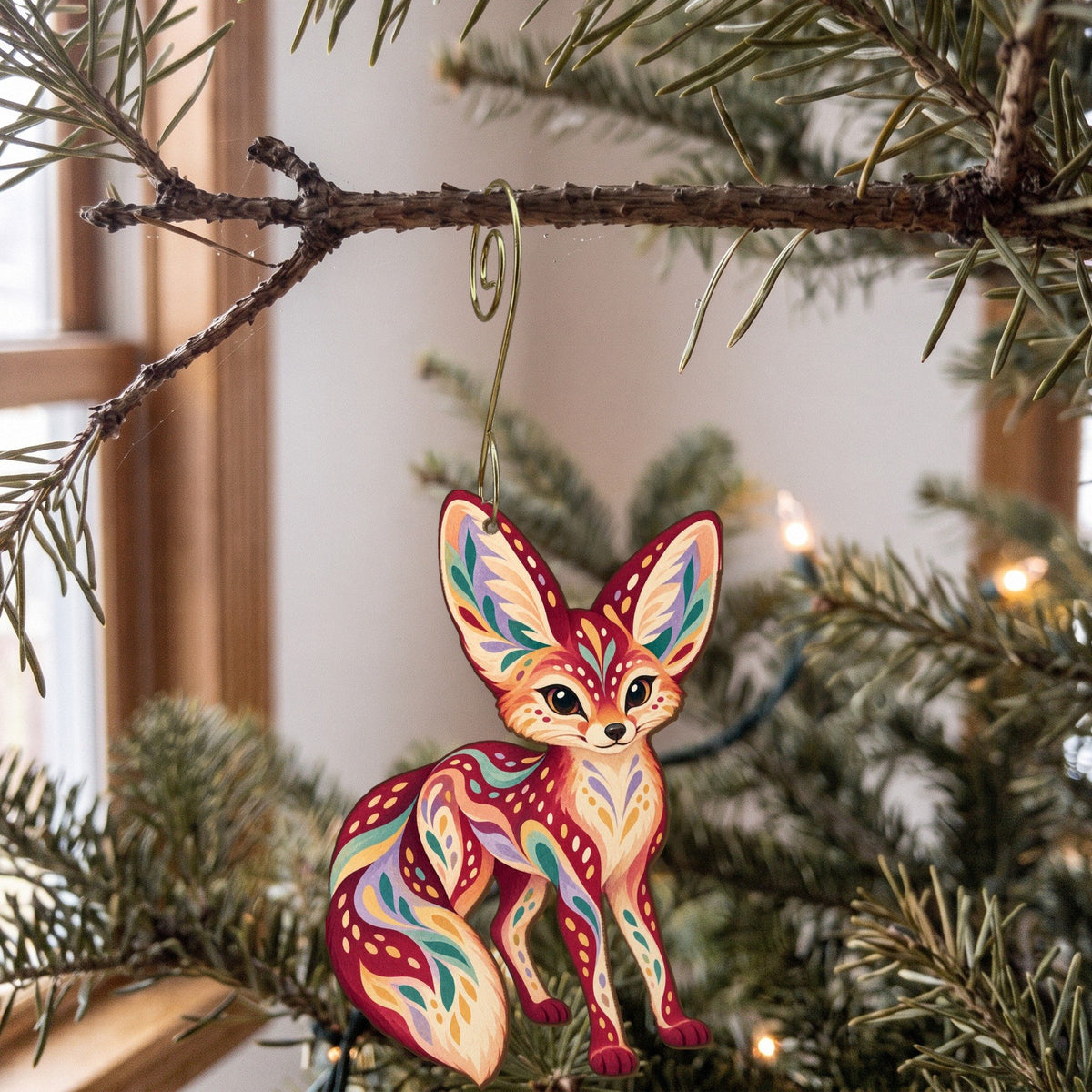 Laser-cut maple wood Fennec Fox folk art ornament O358 hanging on a fir branch, made in USA