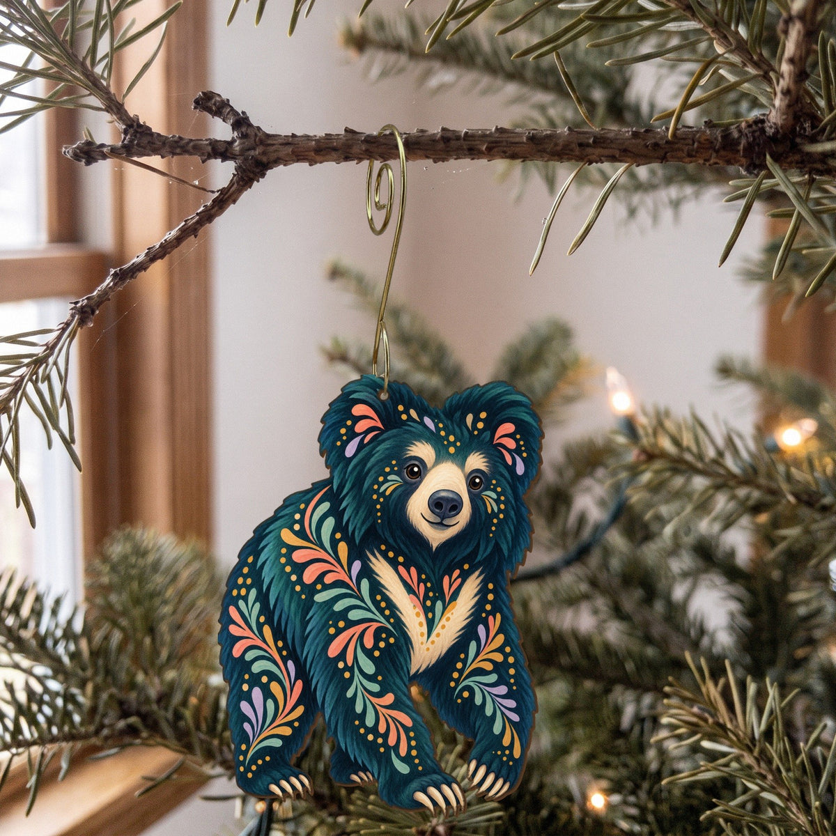 Laser-cut maple wood Sloth Bear folk art ornament O367 hanging on a fir branch, made in USA