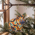 Laser-cut maple wood Hippopotamus folk art ornament O370 hanging on a fir branch, made in USA