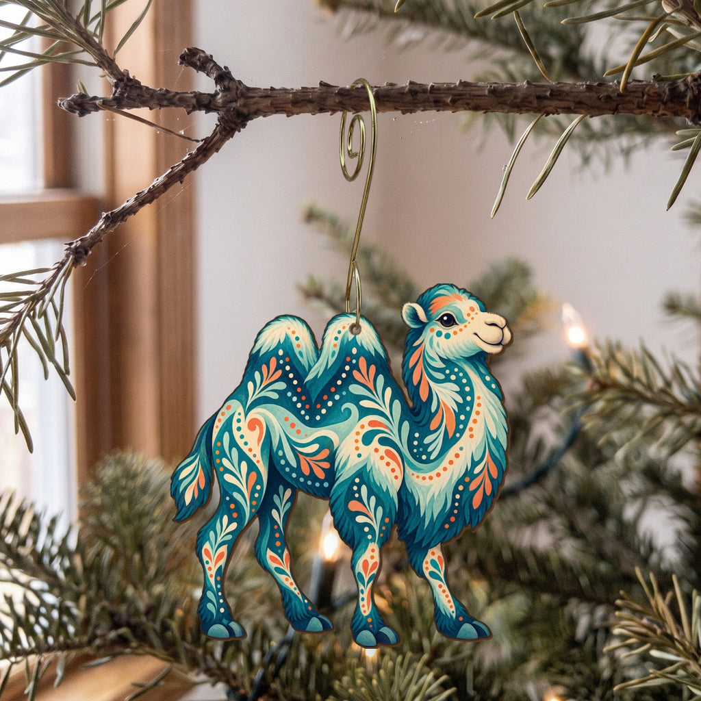 Laser-cut maple wood Bactrian Camel folk art ornament O377 hanging on a fir branch, made in USA