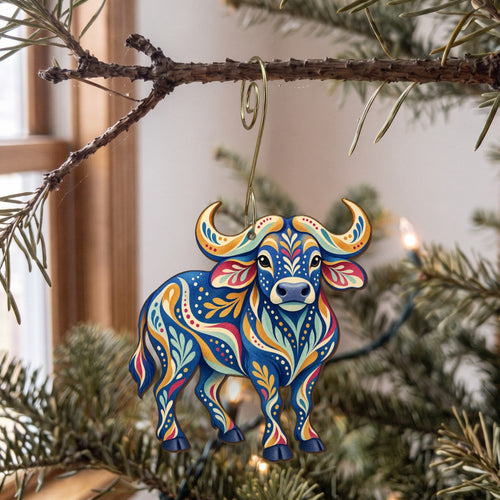 Laser-cut maple wood African Buffalo folk art ornament O381 hanging on a fir branch, made in USA