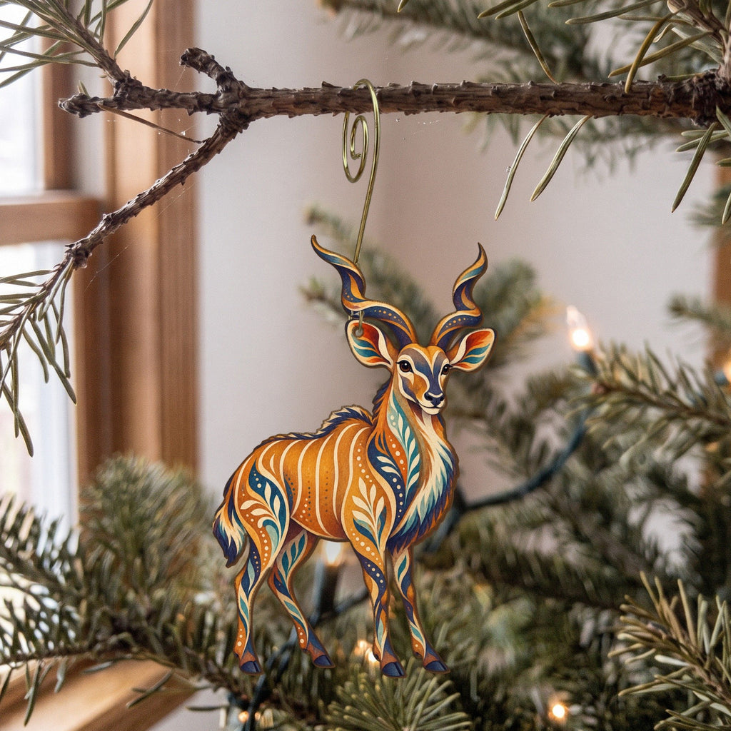 Laser-cut maple wood Greater Kudu folk art ornament O386 hanging on a fir branch, made in USA