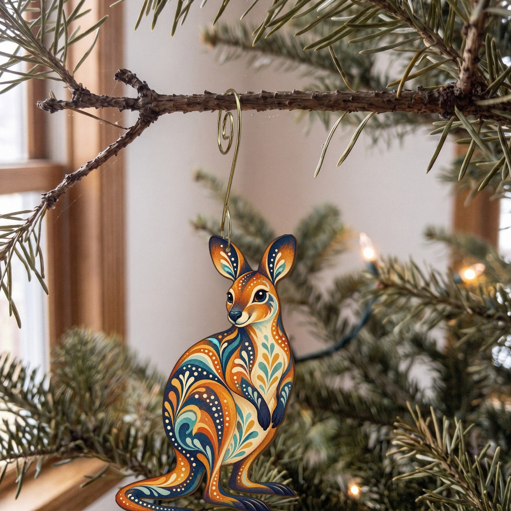 Laser-cut maple wood Wallaby folk art ornament O394 hanging on a fir branch, made in USA