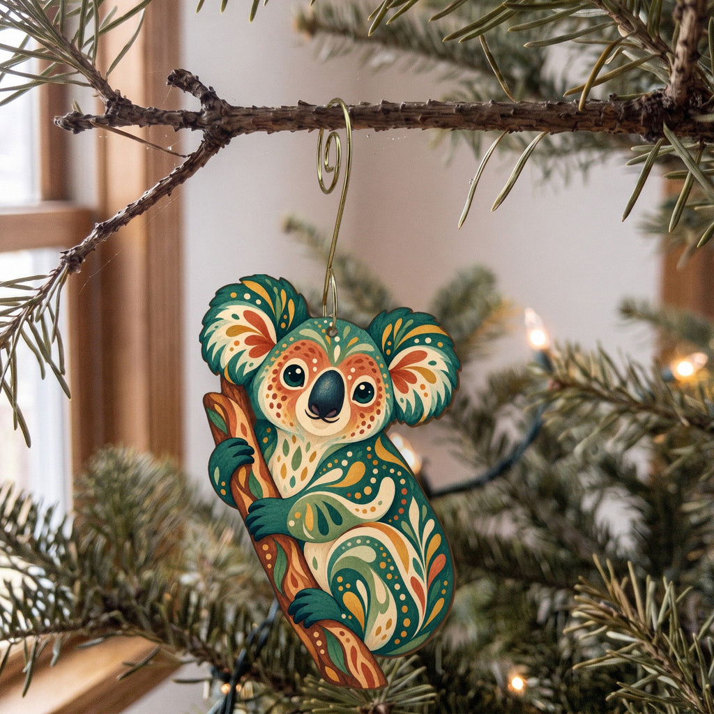 Laser-cut maple wood Koala folk art ornament O395 hanging on a fir branch, made in USA