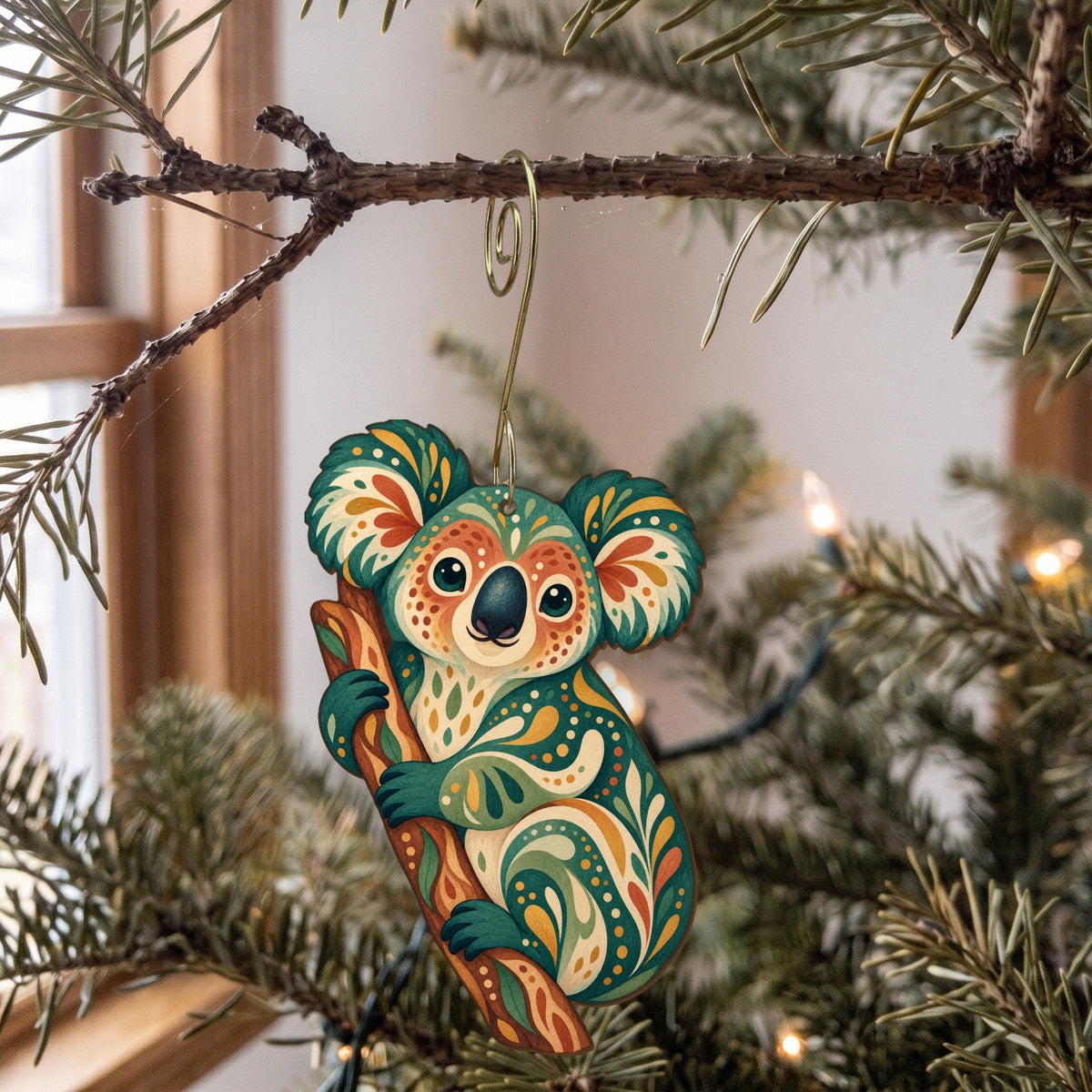 Laser-cut maple wood Koala folk art ornament O395 hanging on a fir branch, made in USA