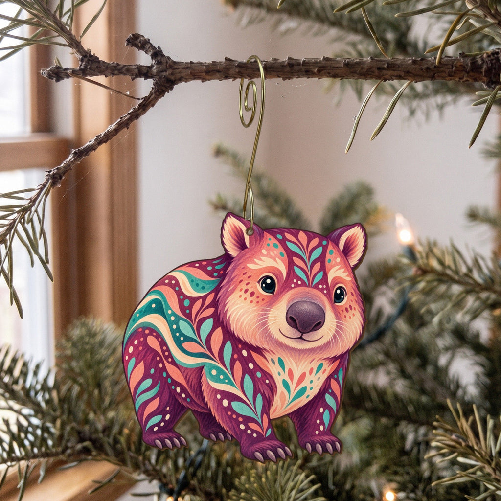 Laser-cut maple wood Wombat folk art ornament O396 hanging on a fir branch, made in USA