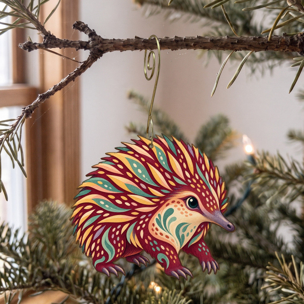 Laser-cut maple wood Short-Beaked Echidna folk art ornament O398 hanging on a fir branch, made in USA