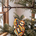 Laser-cut maple wood Three-Toed Sloth folk art ornament O402 hanging on a fir branch, made in USA