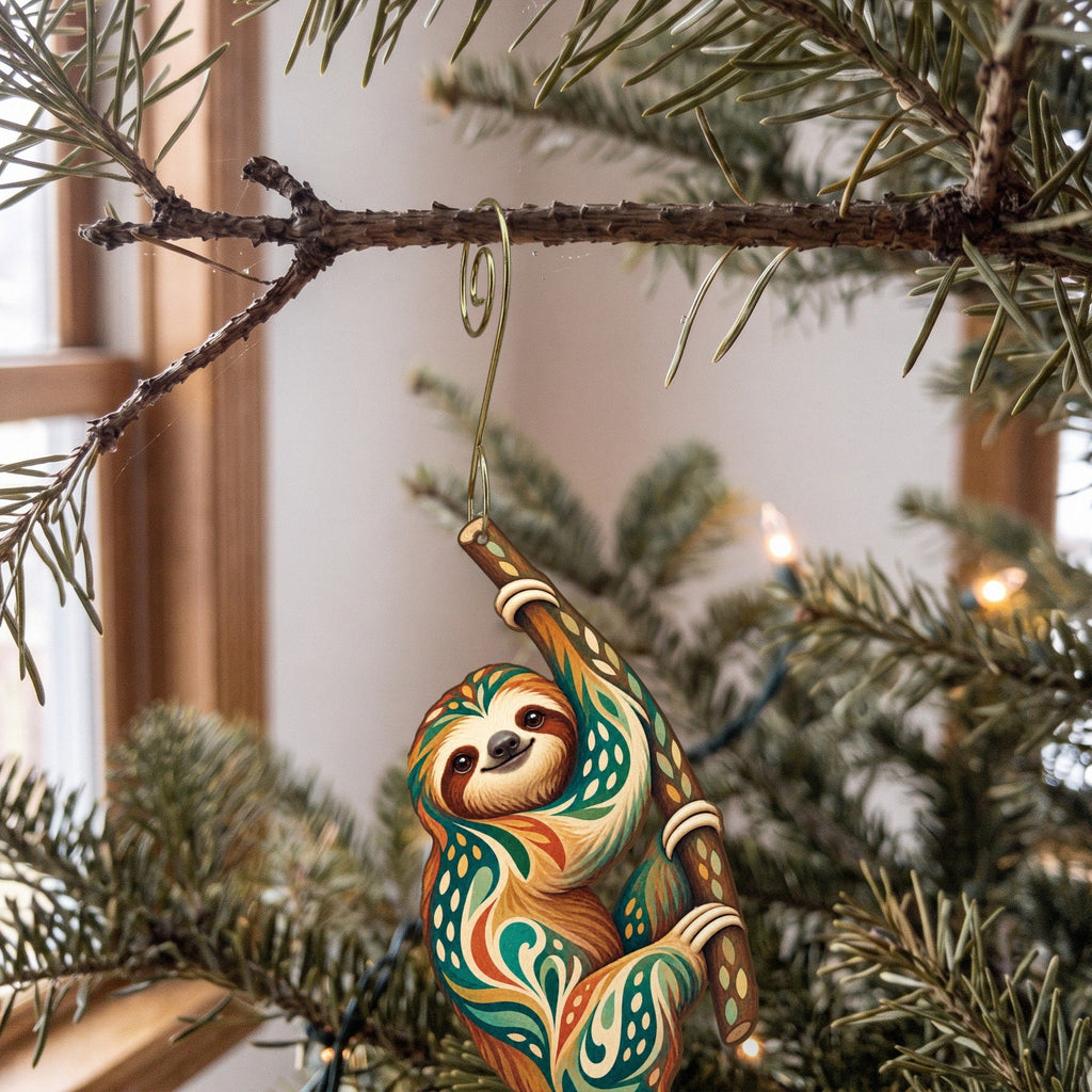 Laser-cut maple wood Two-Toed Sloth folk art ornament O403 hanging on a fir branch, made in USA