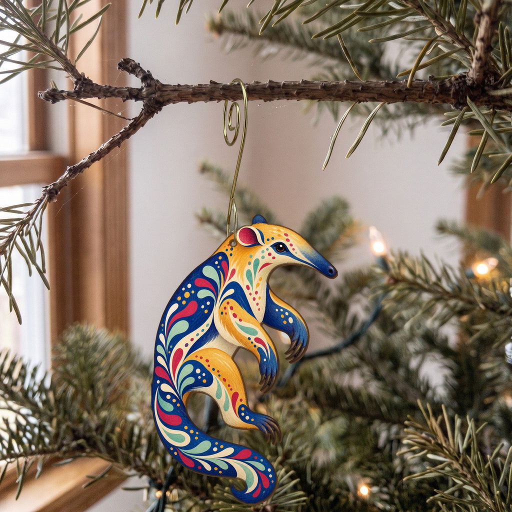 Laser-cut maple wood Tamandua folk art ornament O405 hanging on a fir branch, made in USA