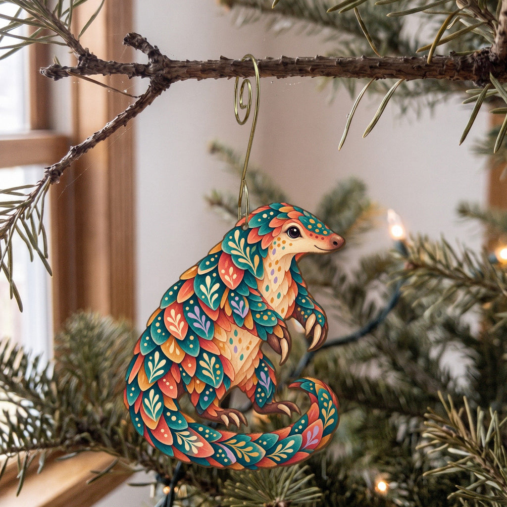 Laser-cut maple wood Ground Pangolin folk art ornament O407 hanging on a fir branch, made in USA