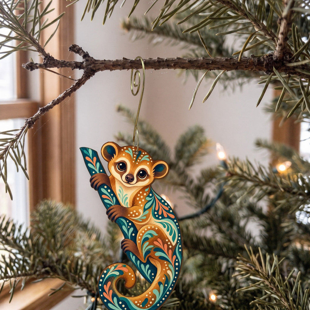 Laser-cut maple wood Kinkajou folk art ornament O409 hanging on a fir branch, made in USA
