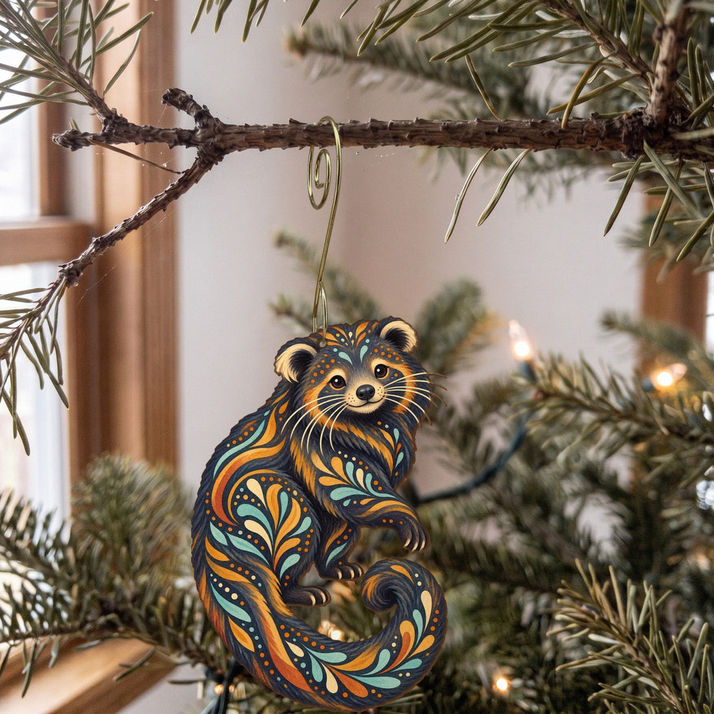 Laser-cut maple wood Binturong folk art ornament O410 hanging on a fir branch, made in USA