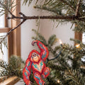 Laser-cut maple wood Orangutan folk art ornament O416 hanging on a fir branch, made in USA
