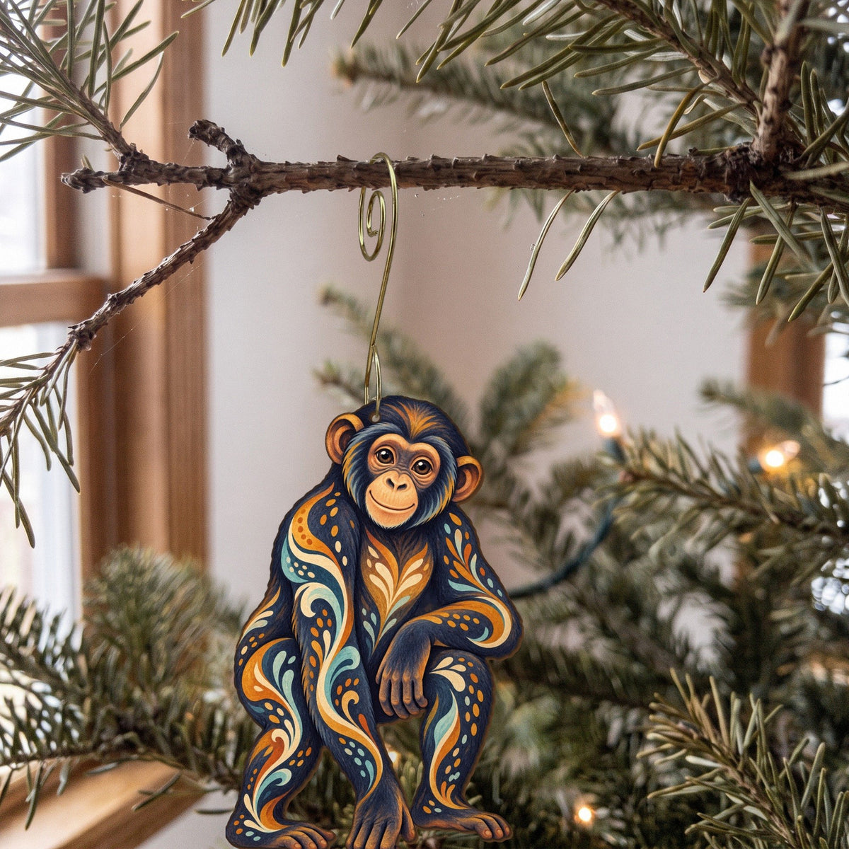 Laser-cut maple wood Bonobo folk art ornament O418 hanging on a fir branch, made in USA