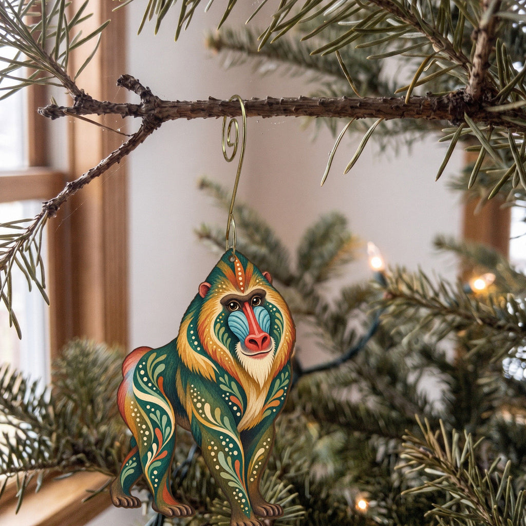 Laser-cut maple wood Mandrill folk art ornament O419 hanging on a fir branch, made in USA