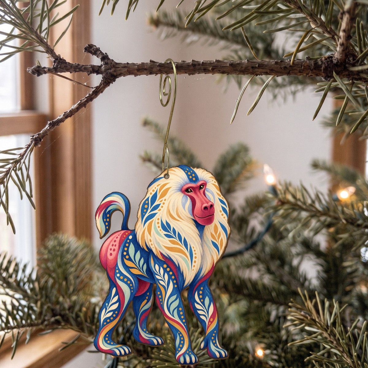 Laser-cut maple wood Hamadryas Baboon folk art ornament O421 hanging on a fir branch, made in USA