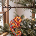 Laser-cut maple wood Golden Lion Tamarin folk art ornament O422 hanging on a fir branch, made in USA