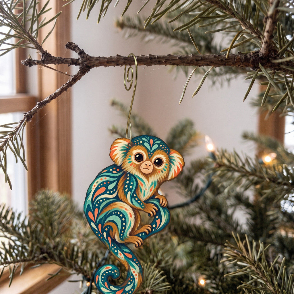 Laser-cut maple wood Pygmy Marmoset folk art ornament O425 hanging on a fir branch, made in USA