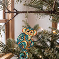 Laser-cut maple wood Pygmy Marmoset folk art ornament O425 hanging on a fir branch, made in USA