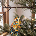 Laser-cut maple wood Squirrel Monkey folk art ornament O426 hanging on a fir branch, made in USA