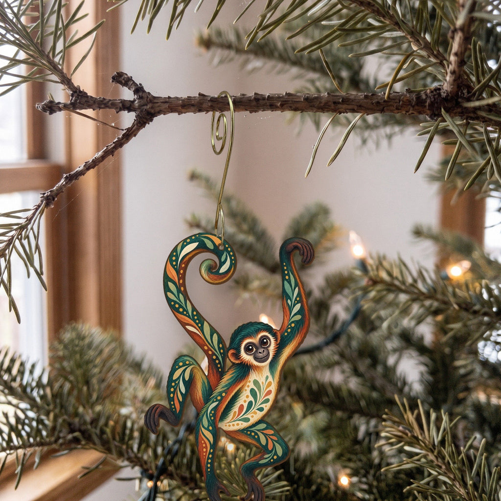 Laser-cut maple wood Spider Monkey folk art ornament O427 hanging on a fir branch, made in USA