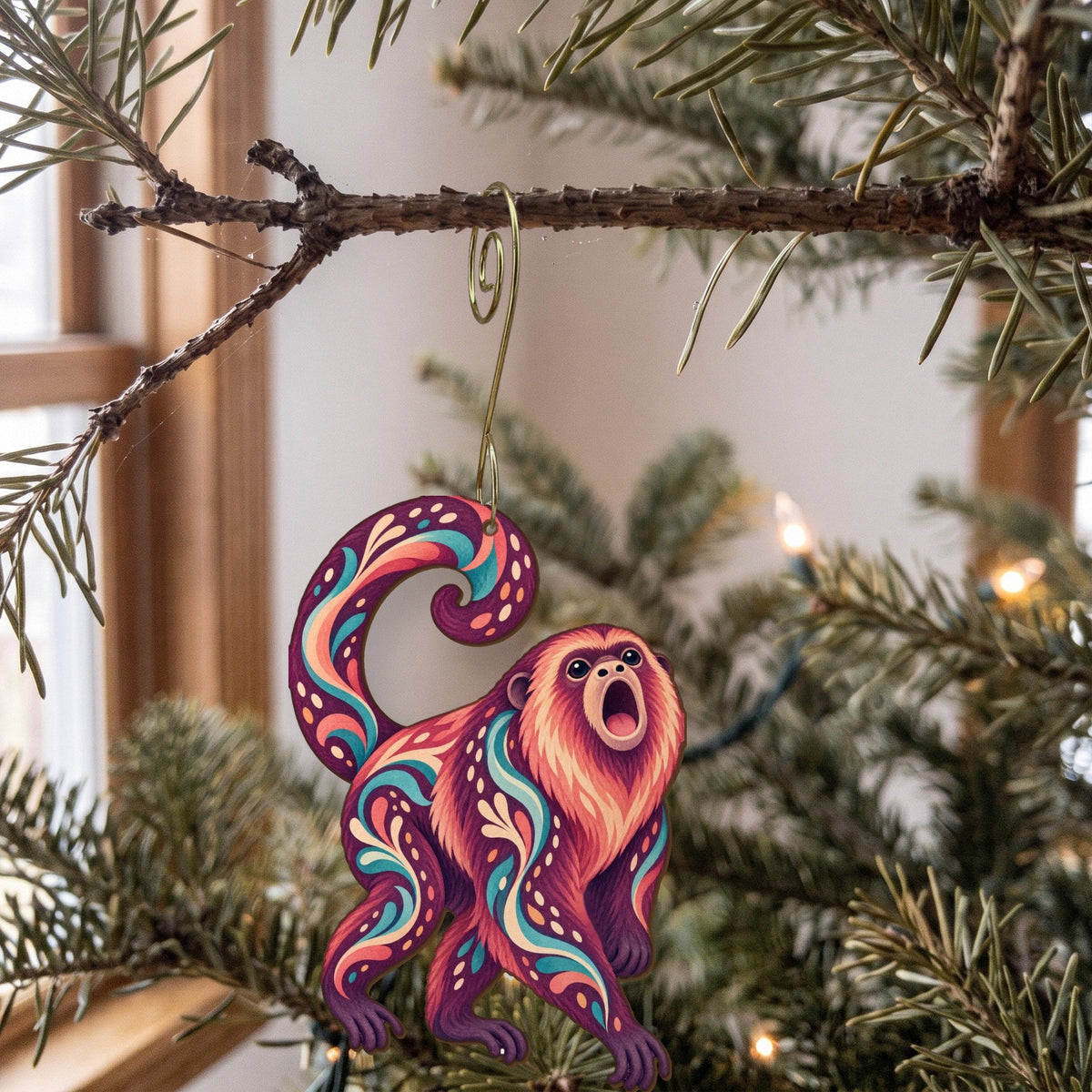 Laser-cut maple wood Howler Monkey folk art ornament O428 hanging on a fir branch, made in USA