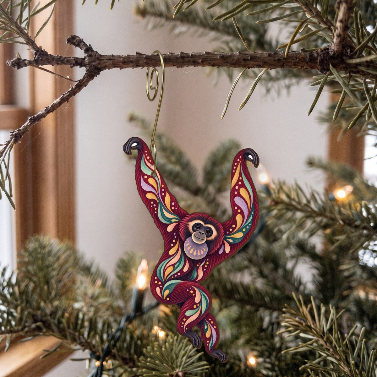 Laser-cut maple wood Siamang folk art ornament O430 hanging on a fir branch, made in USA