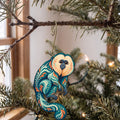Laser-cut maple wood Saki Monkey folk art ornament O433 hanging on a fir branch, made in USA