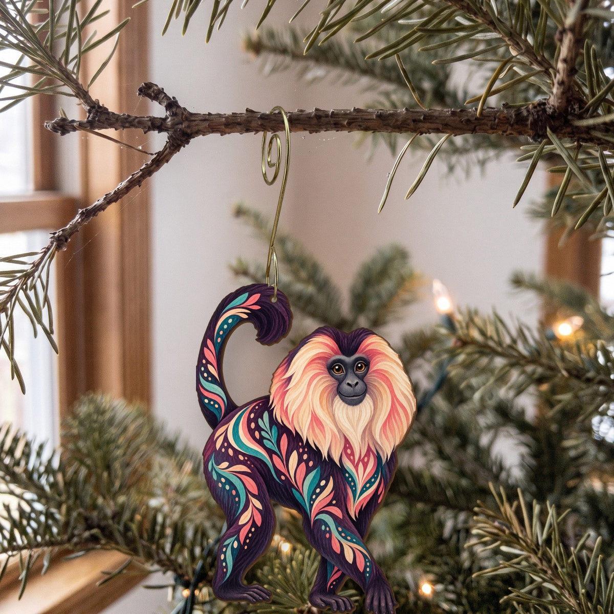 Laser-cut maple wood Lion-Tailed Macaque folk art ornament O436 hanging on a fir branch, made in USA