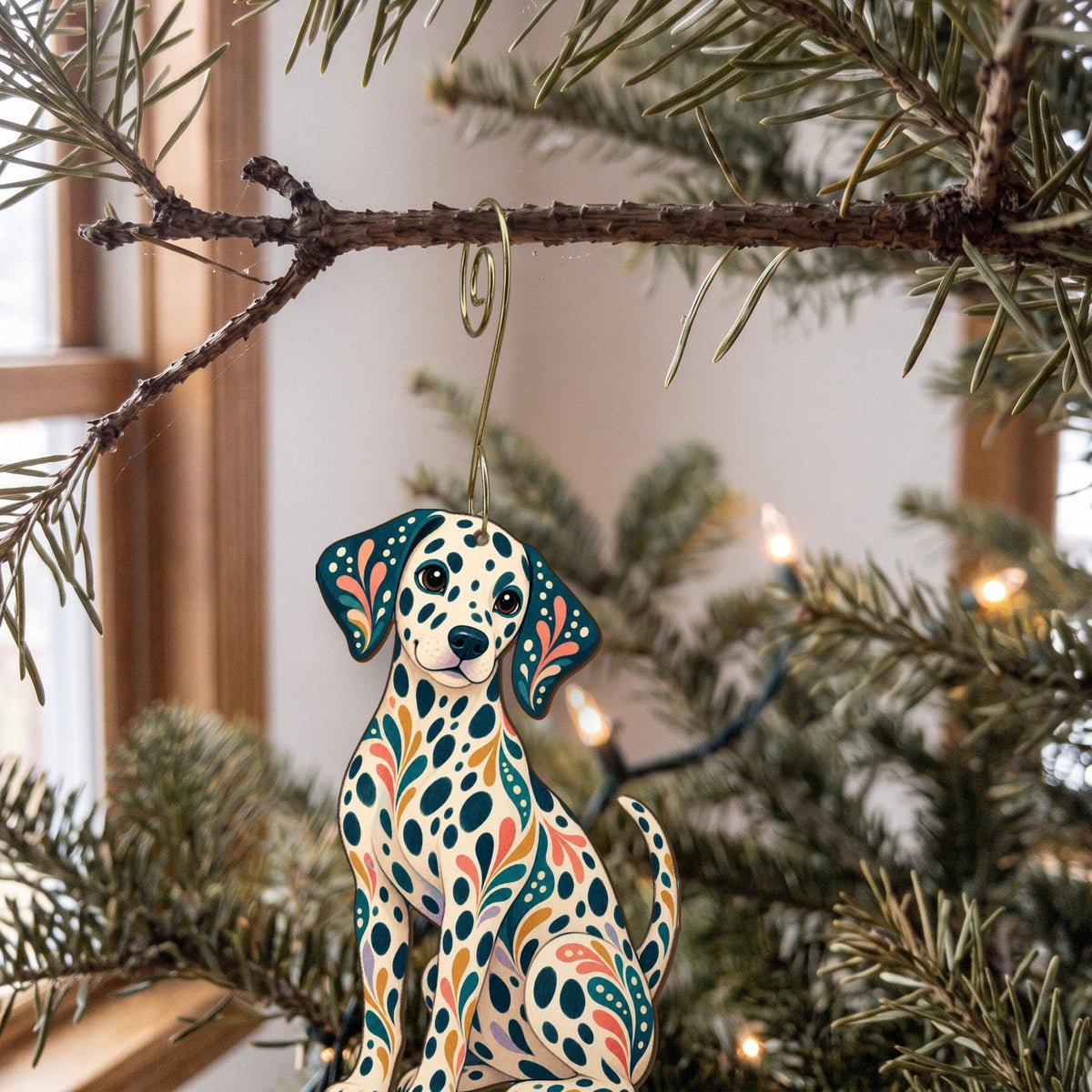 Laser-cut maple wood Dalmatian folk art ornament O439 hanging on a fir branch, made in USA