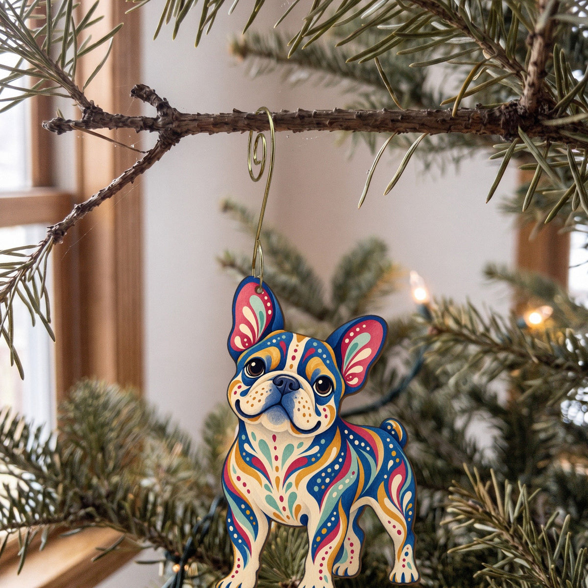 Laser-cut maple wood French Bulldog folk art ornament O445 hanging on a fir branch, made in USA