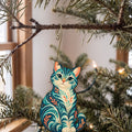Laser-cut maple wood Tabby Cat folk art ornament O457 hanging on a fir branch, made in USA