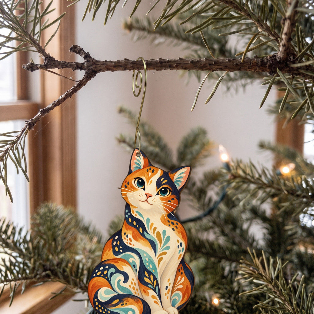 Laser-cut maple wood Calico Cat folk art ornament O458 hanging on a fir branch, made in USA