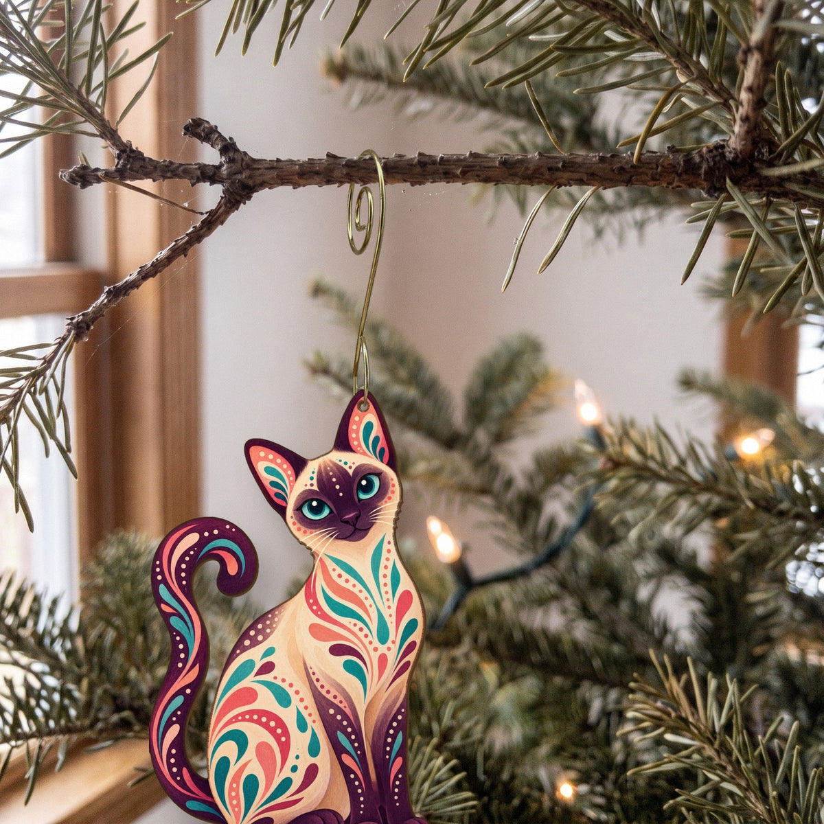 Laser-cut maple wood Siamese Cat folk art ornament O460 hanging on a fir branch, made in USA